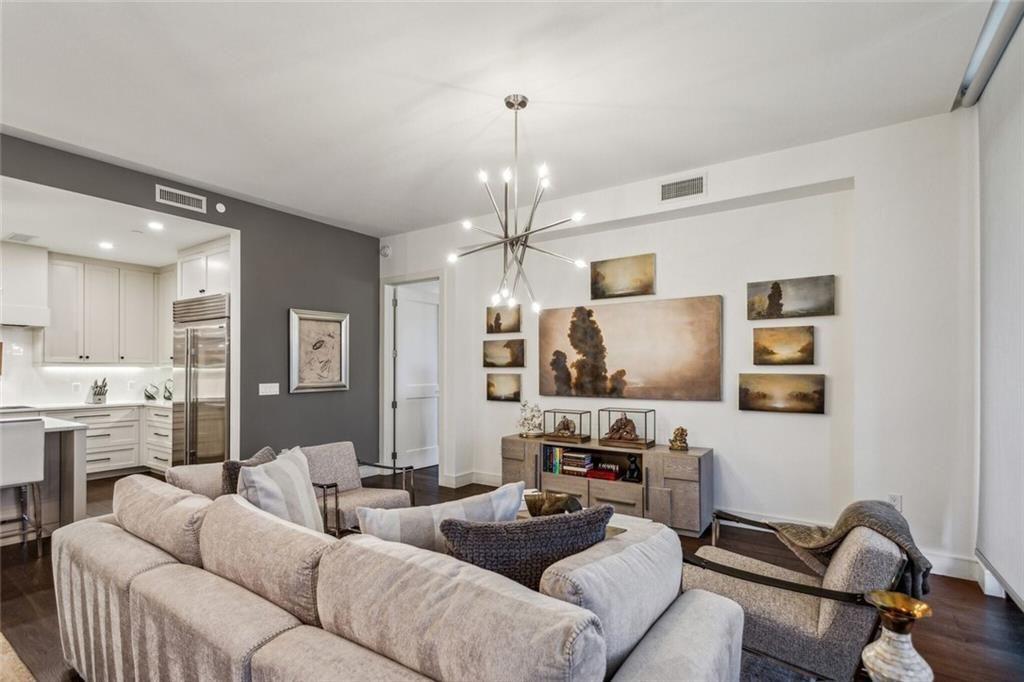 2520 Peachtree Road, Unit 602 Atlanta, GA 30305 - Photo 5 of 45 a living room with furniture kitchen view and a chandelier