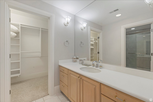 3222 Eagle View Circle Sandy, UT 84092 - Photo 38 of 60 Bathroom featuring a spacious closet, vanity, light colored carpet, and recessed lighting
