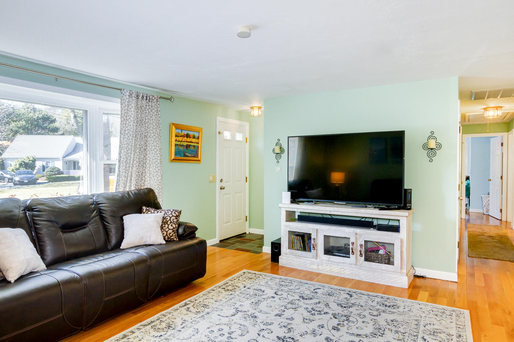 212 Skunknet Road Centerville, MA 02632 - Photo 15 of 45 a living room with furniture and a flat screen tv