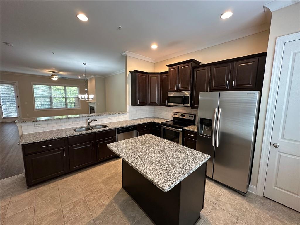 2417 Tenor Lane Alpharetta, GA 30009 - Photo 12 of 43 a kitchen with stainless steel appliances granite countertop a sink a stove a refrigerator a center a sink and a refrigerator