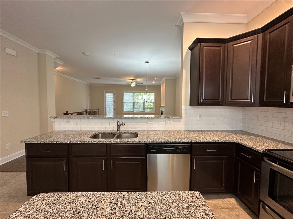 2417 Tenor Lane Alpharetta, GA 30009 - Photo 13 of 43 a kitchen with granite countertop a sink and cabinets