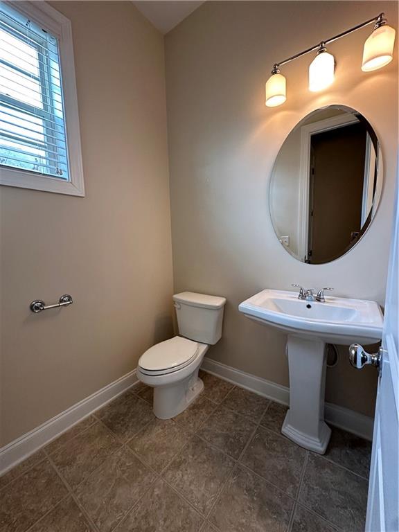 2417 Tenor Lane Alpharetta, GA 30009 - Photo 14 of 43 a bathroom with a sink toilet and mirror