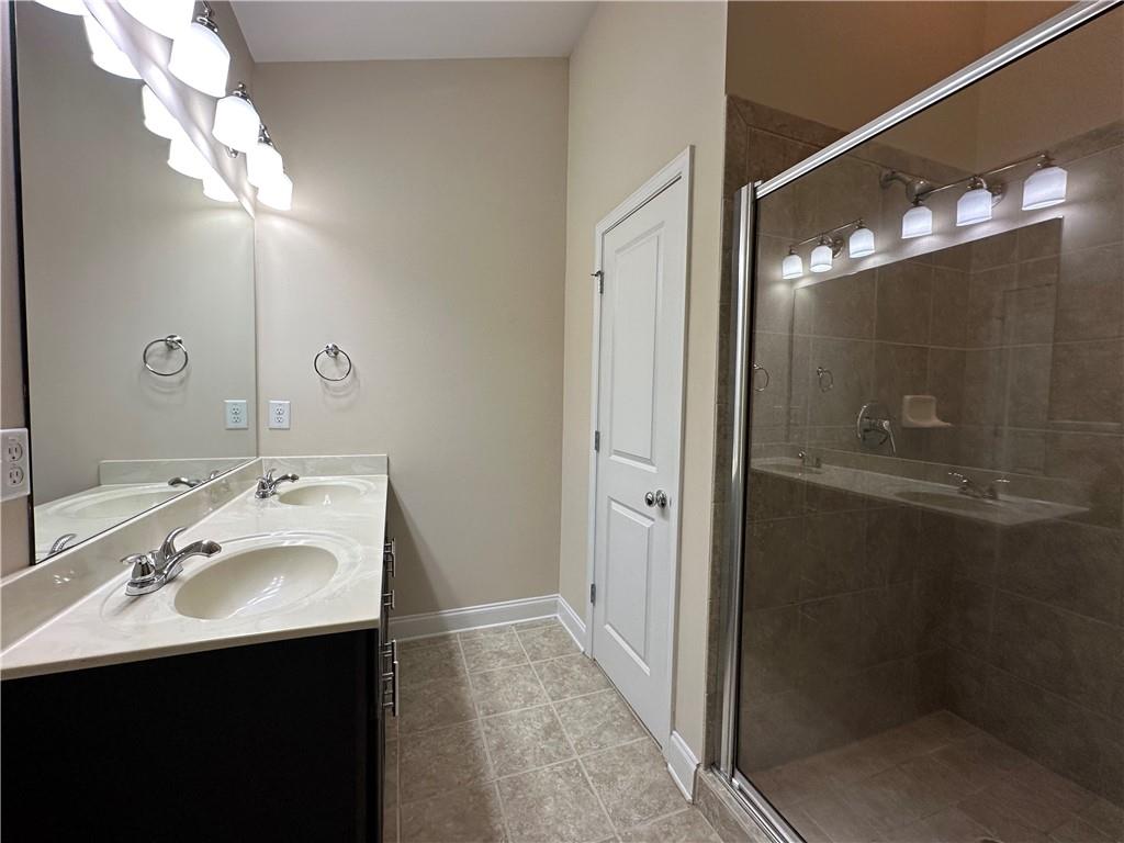 2417 Tenor Lane Alpharetta, GA 30009 - Photo 25 of 43 a bathroom with a sink vanity and mirror