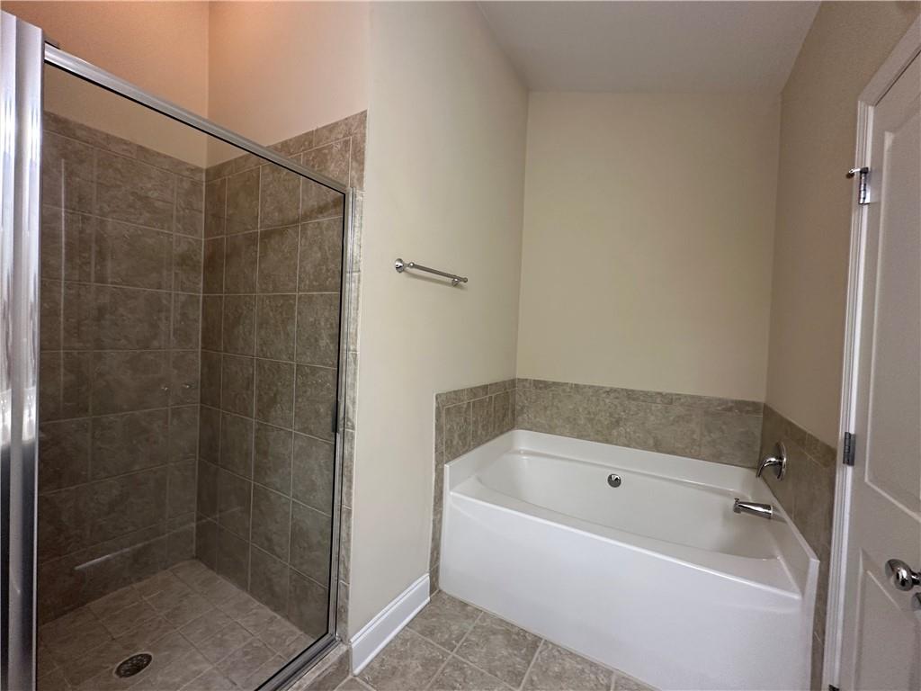 2417 Tenor Lane Alpharetta, GA 30009 - Photo 26 of 43 a bathroom with a bathtub and a shower