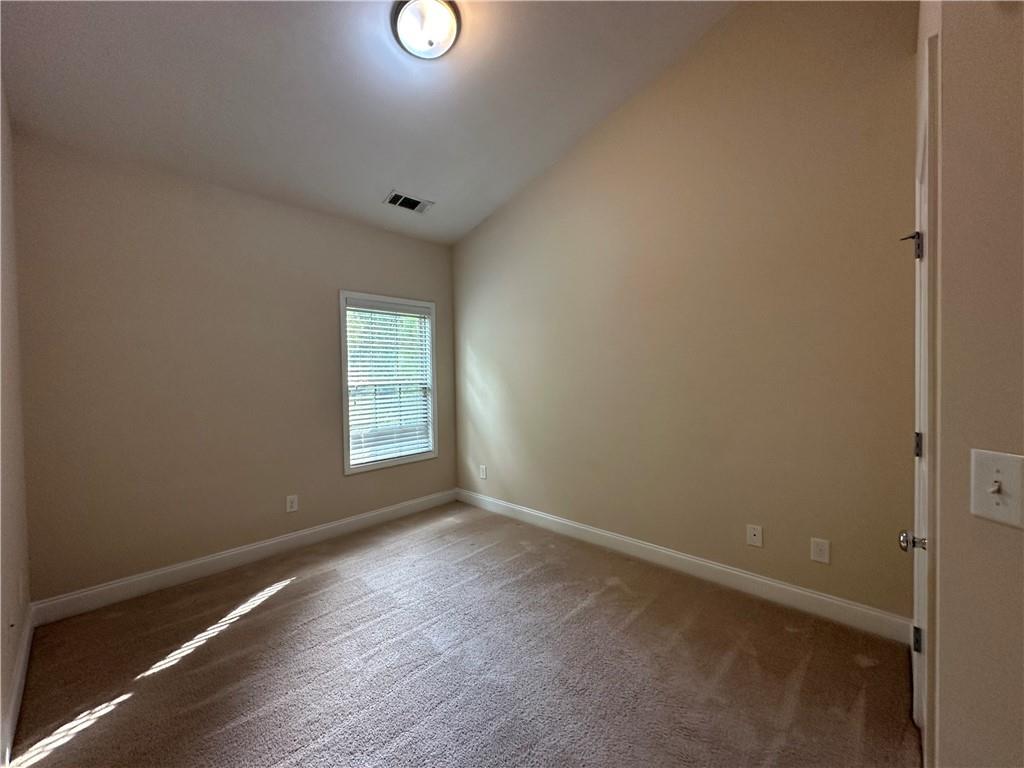 2417 Tenor Lane Alpharetta, GA 30009 - Photo 30 of 43 a view of an empty room with wooden floor and a window