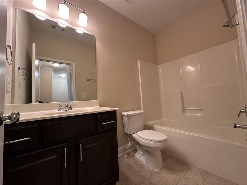 2417 Tenor Lane Alpharetta, GA 30009 - Photo 35 of 43 a bathroom with a double vanity sink toilet mirror and bathtub