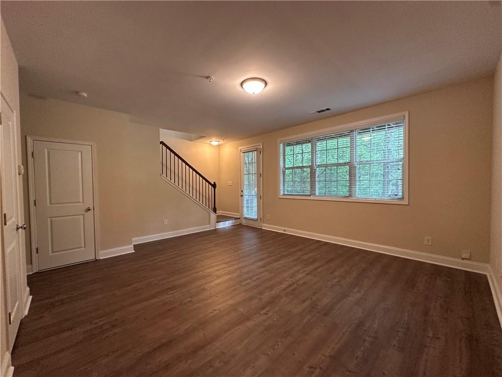 2417 Tenor Lane Alpharetta, GA 30009 - Photo 39 of 43 an empty room with wooden floor and windows