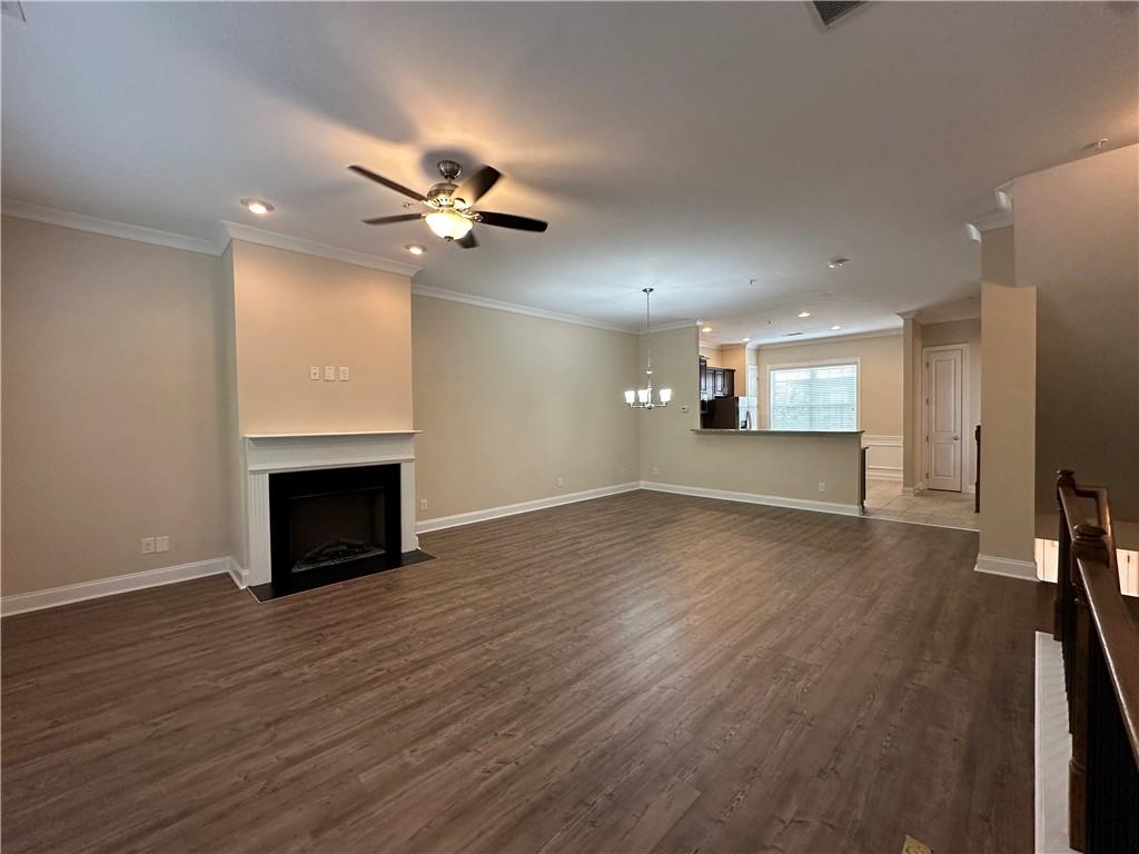 2417 Tenor Lane Alpharetta, GA 30009 - Photo 4 of 43 an empty room with wooden floor fireplace and a window