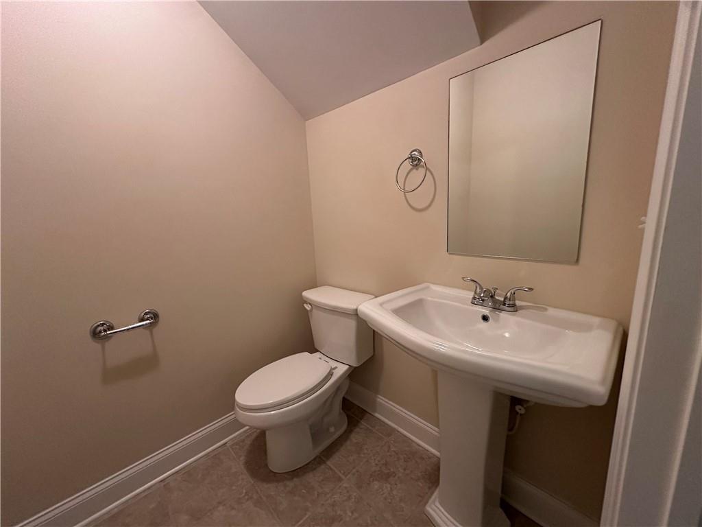2417 Tenor Lane Alpharetta, GA 30009 - Photo 41 of 43 a bathroom with a toilet sink and mirror