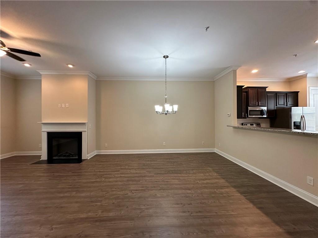 2417 Tenor Lane Alpharetta, GA 30009 - Photo 5 of 43 an empty room with wooden floor fireplace and windows