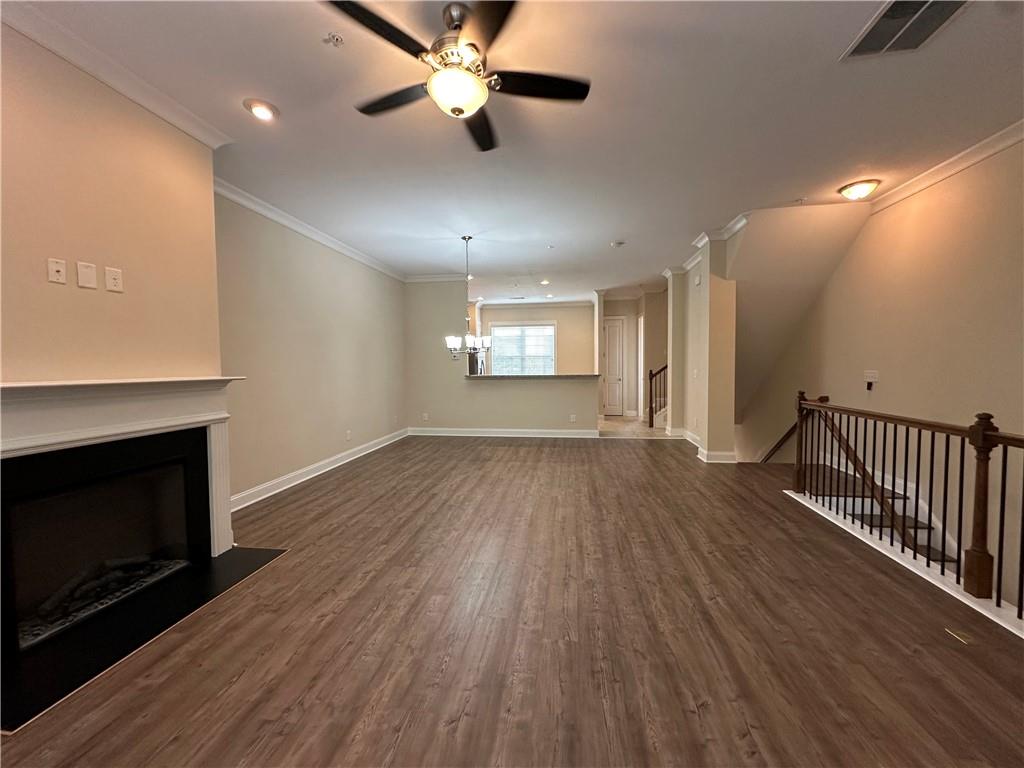 2417 Tenor Lane Alpharetta, GA 30009 - Photo 7 of 43 an empty room with wooden floor fireplace and windows