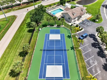 an aerial view of a swimming pool with a yard