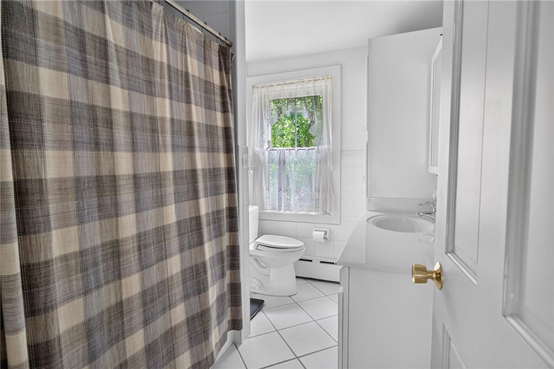 765 East Macada Road Bethlehem, PA 18017 - Photo 34 of 46 A well-lit lavatory features a crisp white vanity and tile flooring for comfortable daily routines.