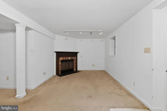 a view of an empty room with a fireplace