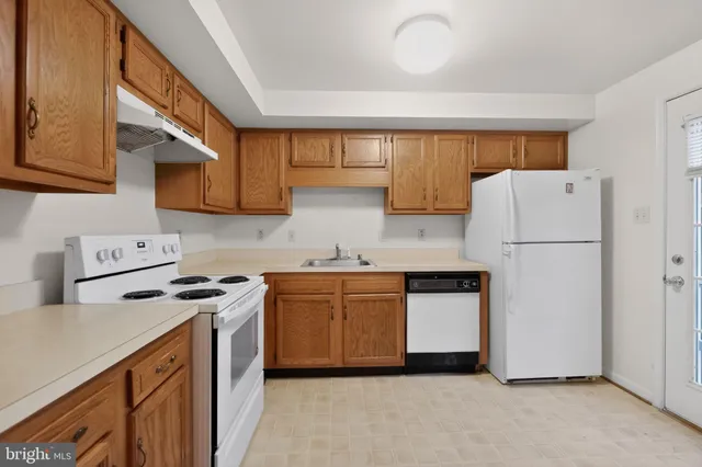 a kitchen with stainless steel appliances granite countertop a refrigerator stove a sink and dishwasher