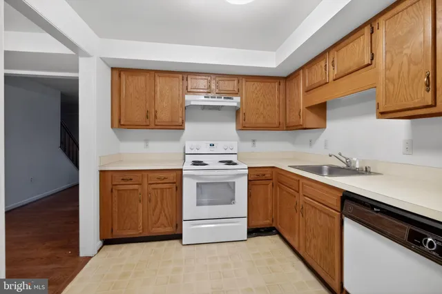 a kitchen with stainless steel appliances granite countertop a sink and cabinets