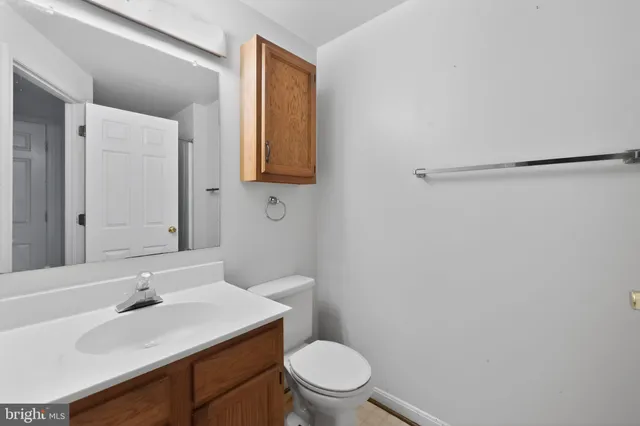 a bathroom with a sink toilet vanity and mirror