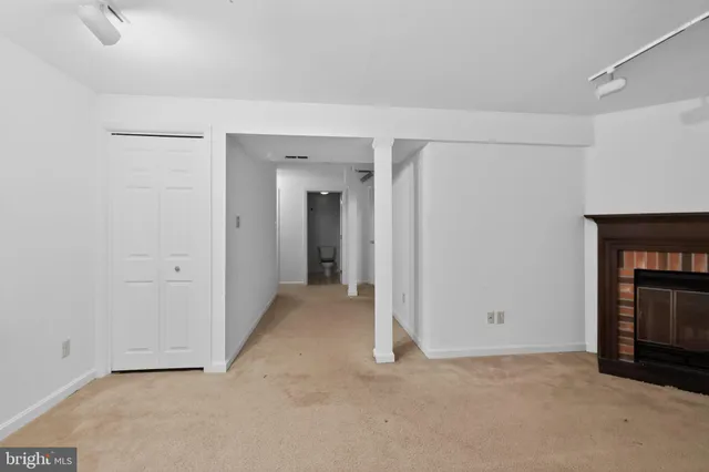 a view of an empty room with a fireplace