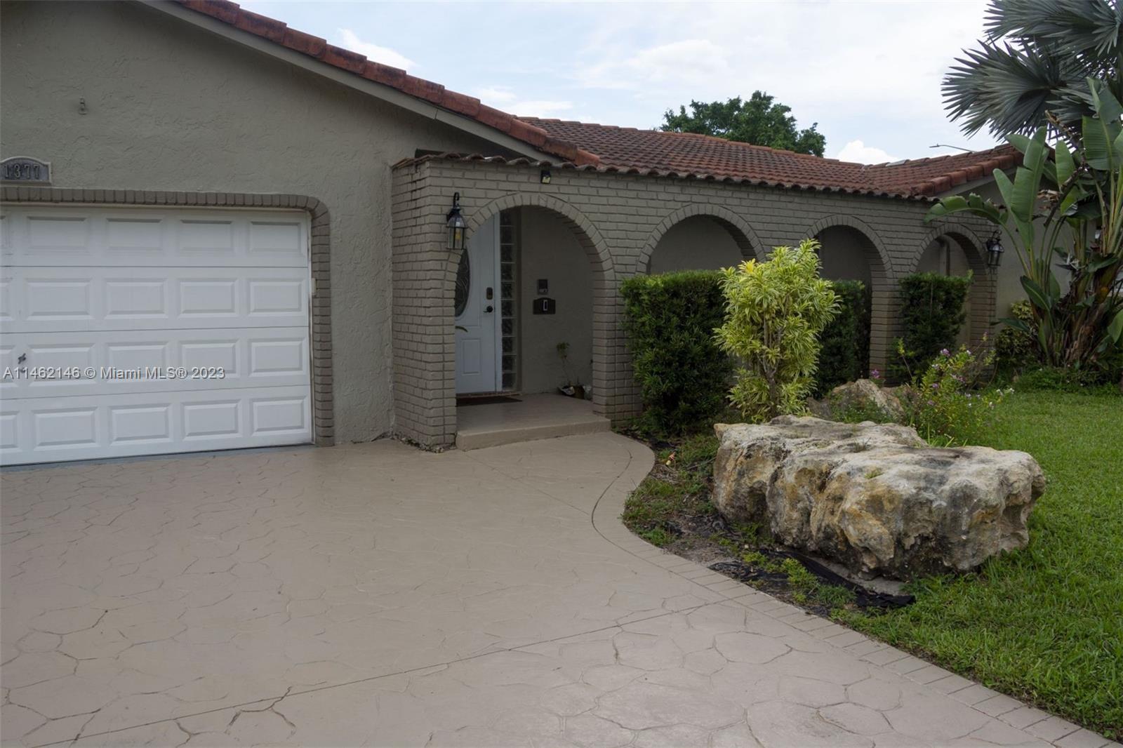 a front view of a house with garden