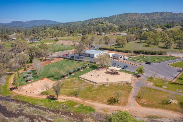 an aerial view of residential houses with outdoor space