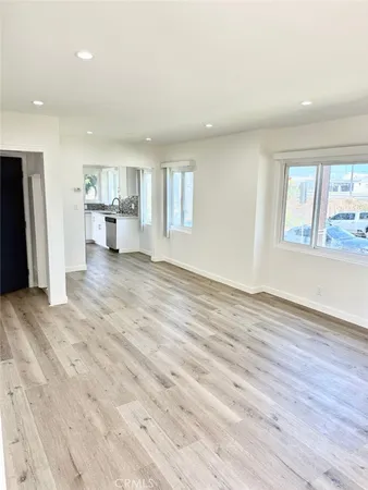 a view of a livingroom with wooden floor and a window