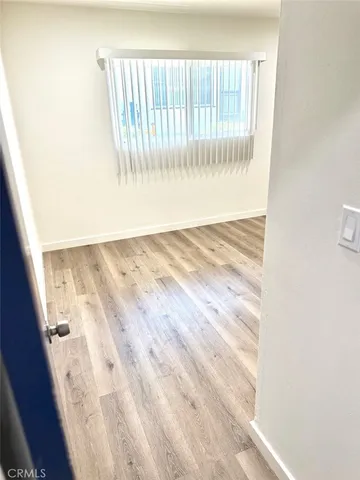 a view of wooden floor and windows in a room