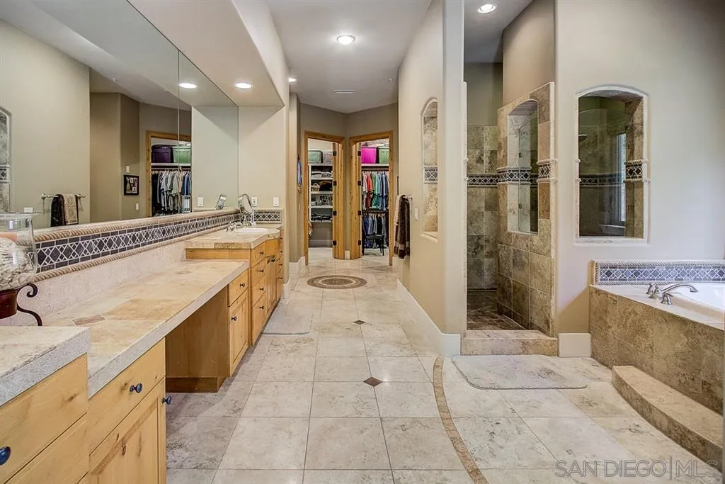 15165 Saddlebrook Lane Poway, CA 92064 - Photo 11 of 25 a large kitchen with stainless steel appliances kitchen island granite countertop a refrigerator and a sink