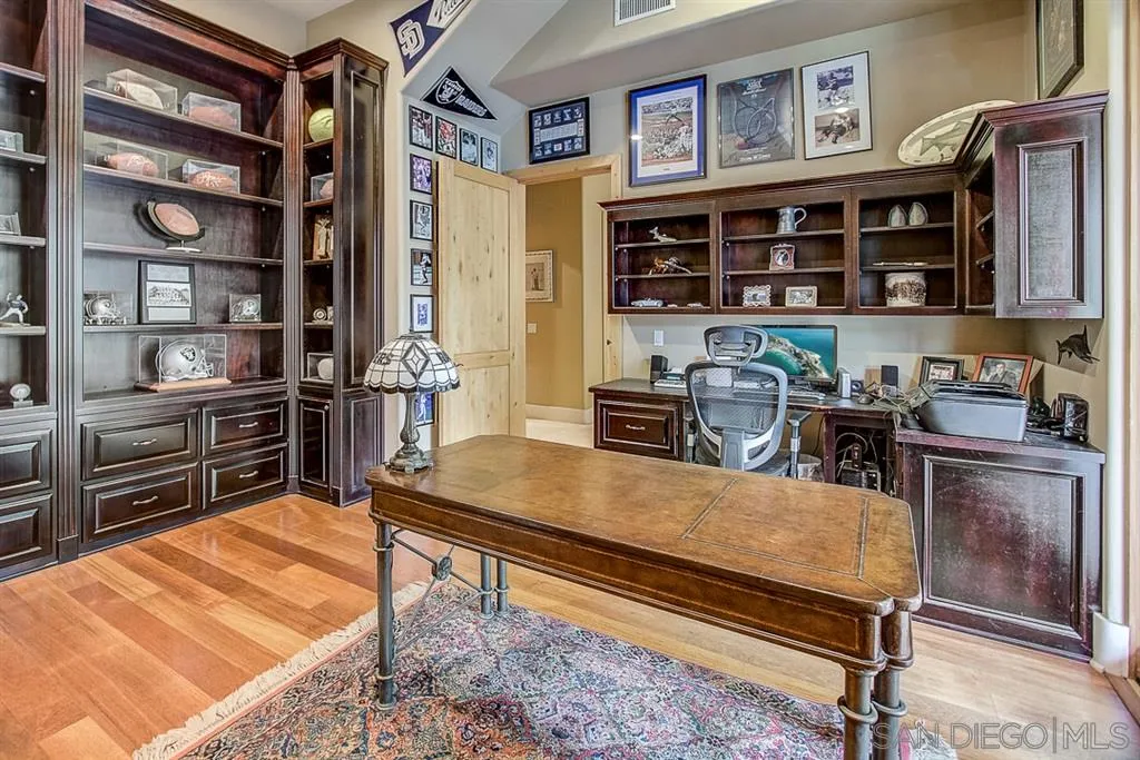15165 Saddlebrook Lane Poway, CA 92064 - Photo 12 of 25 a kitchen with stainless steel appliances kitchen island granite countertop a refrigerator and cabinets