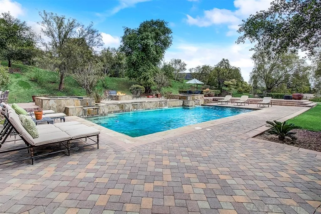15165 Saddlebrook Lane Poway, CA 92064 - Photo 20 of 25 a view of a patio with dining table and chairs with wooden fence