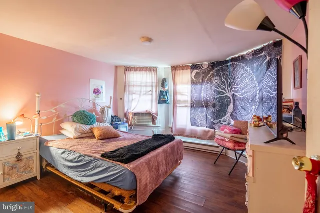 a bedroom with furniture and a window