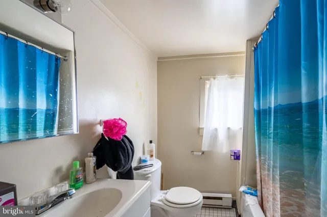 a bathroom with a sink mirror vanity and toilet