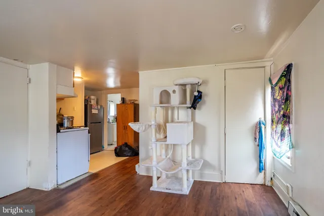a view of a living room with furniture and wooden floor