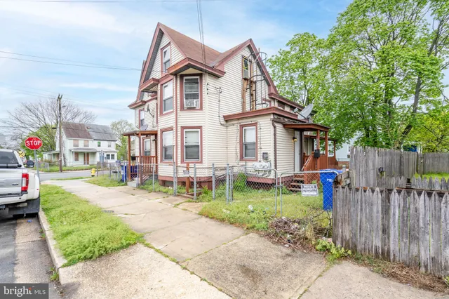 a view of a house with backyard porch and sitting area