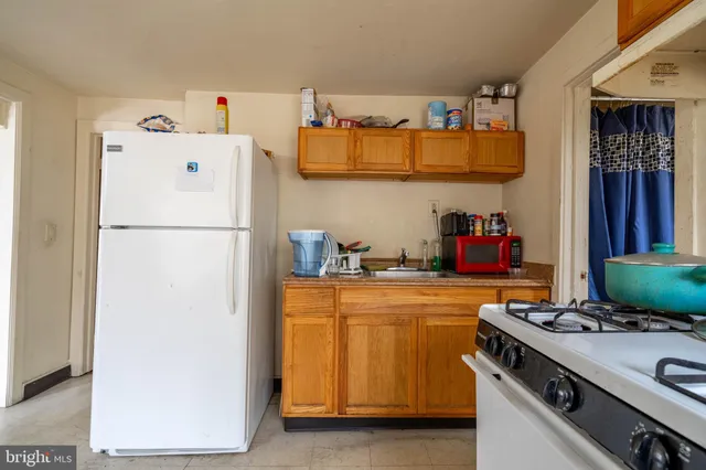a kitchen with a stove and a refrigerator
