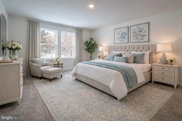 a spacious bedroom with a bed a couch and potted plant