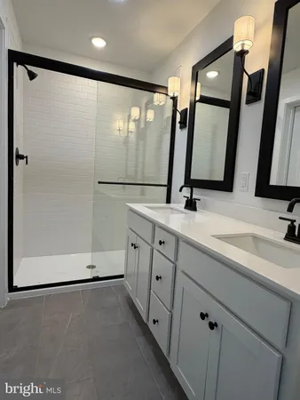 a bathroom with a double vanity sink and mirror