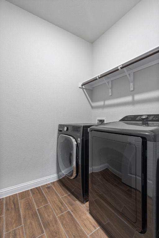 8301 Turnberry Lane Austin, TX 78744 - Photo 12 of 33 Washroom with wood finish floors and independent washer and dryer