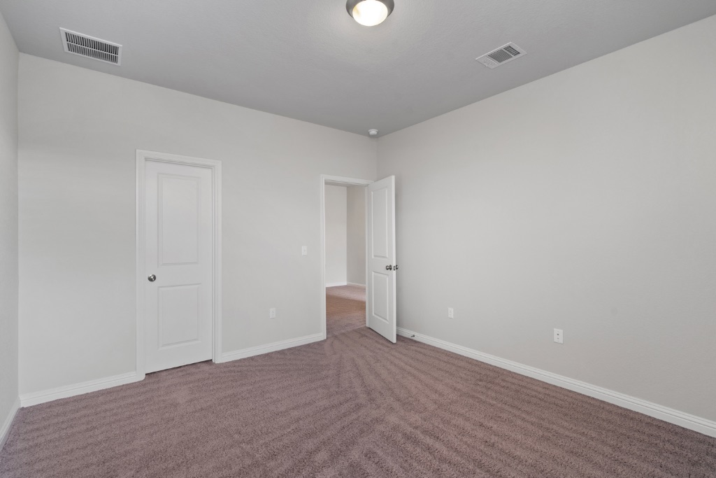 8301 Turnberry Lane Austin, TX 78744 - Photo 21 of 33 Unfurnished bedroom featuring baseboards and carpet flooring