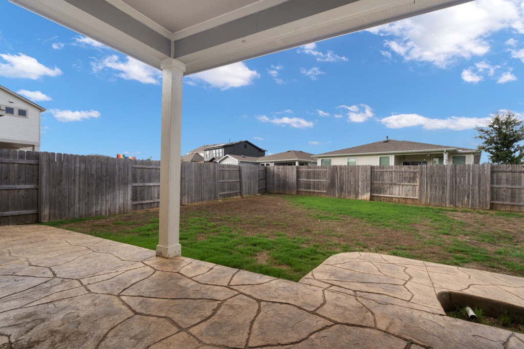 8301 Turnberry Lane Austin, TX 78744 - Photo 27 of 33 Fenced backyard with a patio area