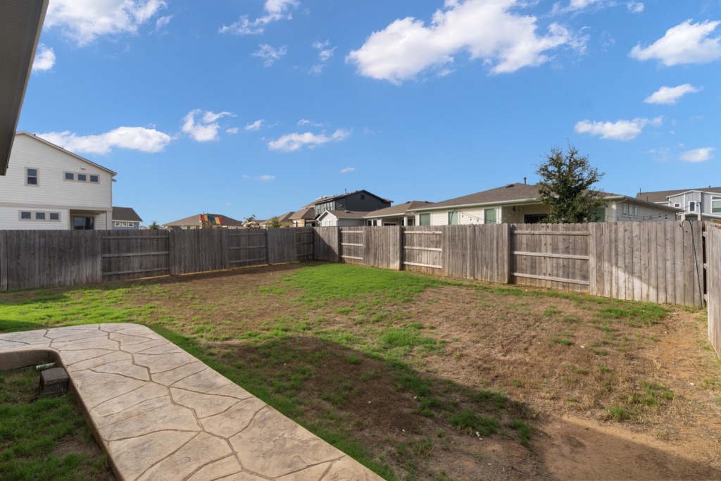 8301 Turnberry Lane Austin, TX 78744 - Photo 28 of 33 Fenced backyard featuring a residential view