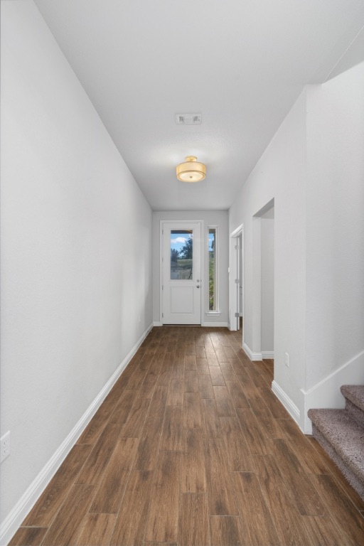 8301 Turnberry Lane Austin, TX 78744 - Photo 3 of 33 Foyer entrance with dark wood-type flooring and stairway