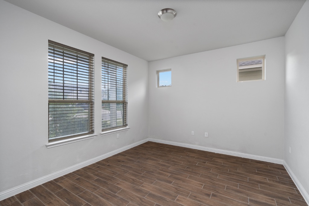 8301 Turnberry Lane Austin, TX 78744 - Photo 4 of 33 Spare room with wood tiled floors and baseboards