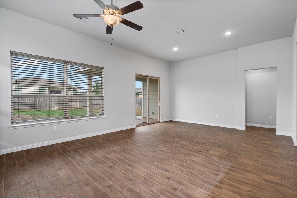 8301 Turnberry Lane Austin, TX 78744 - Photo 9 of 33 Unfurnished room with wood tiled floors, a ceiling fan, and recessed lighting