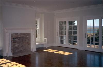 Undisclosed Address Barnstable, MA 02630 - Photo 4 of 13 a view of empty room with wooden floor and fireplace