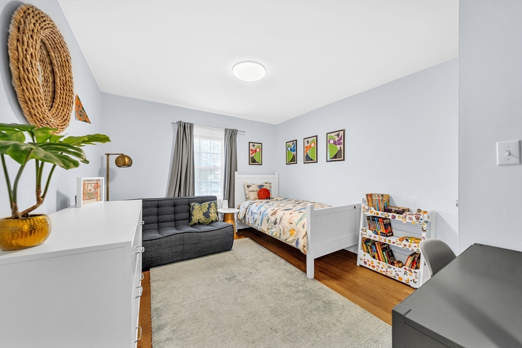 69 Donizetti Street Wellesley, MA 02482 - Photo 14 of 29 a bedroom with furniture and a potted plant