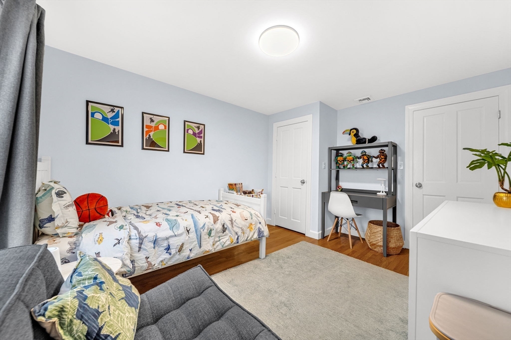 69 Donizetti Street Wellesley, MA 02482 - Photo 15 of 29 a bedroom with a bed and a desk in it