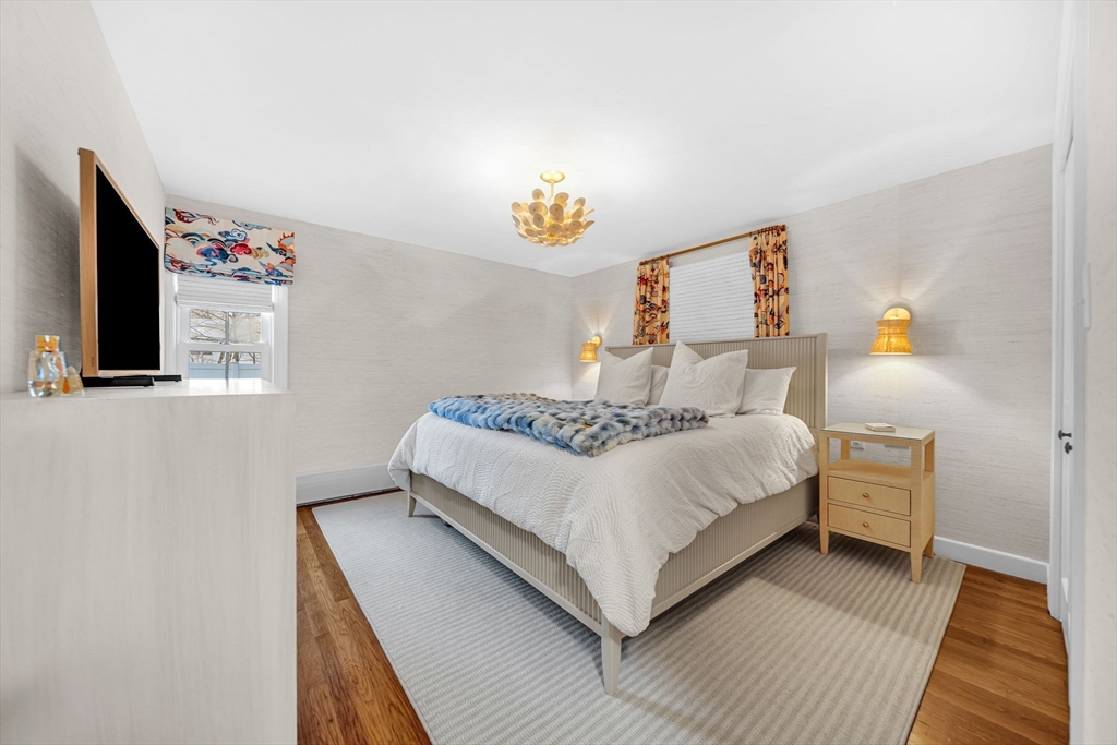 69 Donizetti Street Wellesley, MA 02482 - Photo 16 of 29 a room with a bed and a flat screen tv