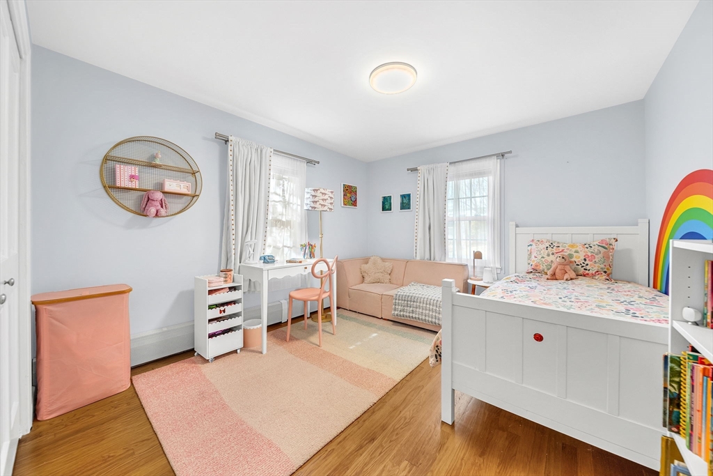 69 Donizetti Street Wellesley, MA 02482 - Photo 18 of 29 a living room with furniture and a baby crib