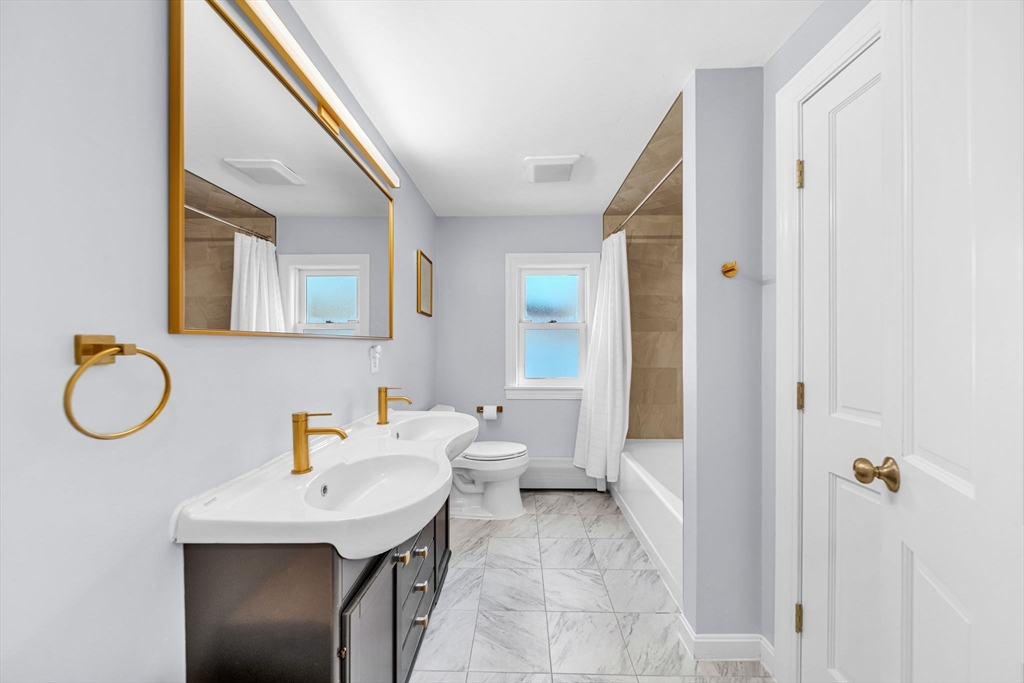 69 Donizetti Street Wellesley, MA 02482 - Photo 20 of 29 a bathroom with a sink and a mirror