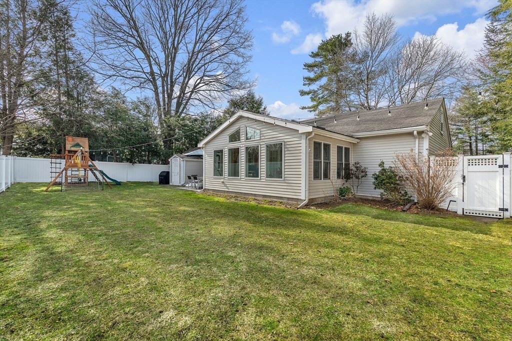 69 Donizetti Street Wellesley, MA 02482 - Photo 25 of 29 a front view of a house with a garden and trees